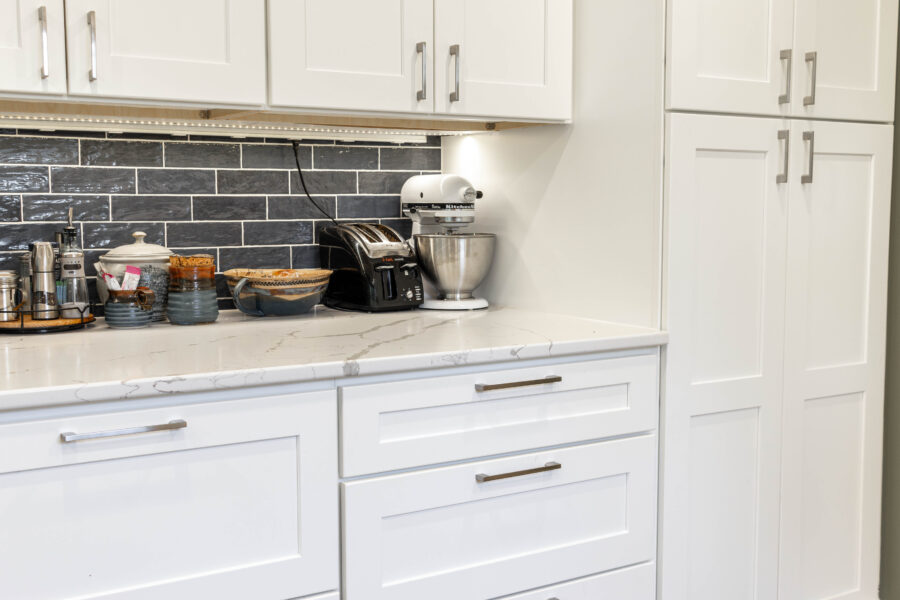white kitchen cabinets with blue tile back splash