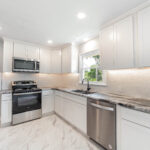 white marble flooring with white kitchen cabinets