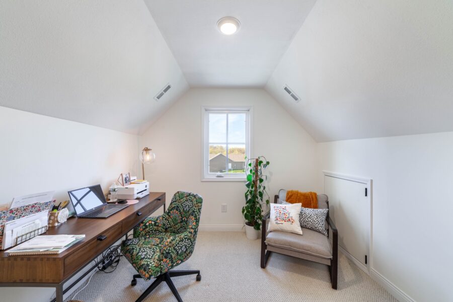 Finished attic office with a desk and a reading chair