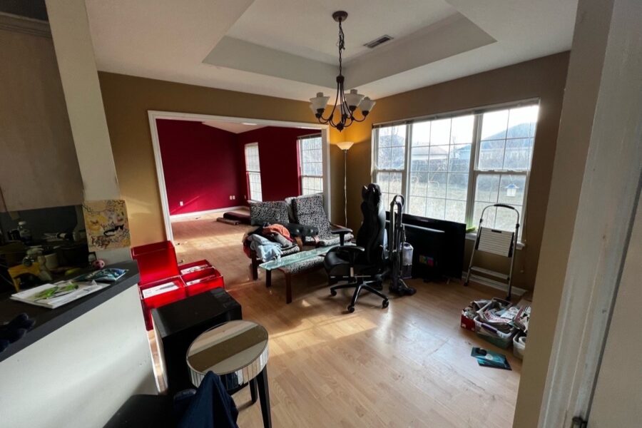 Living room with a dark red wall before make-ready work